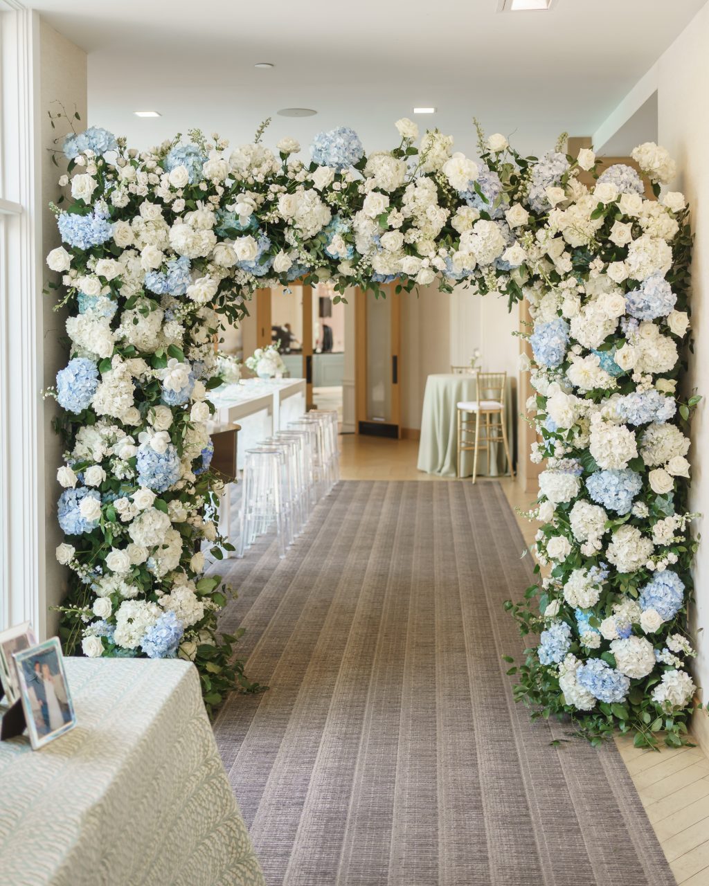 Abundant blue and white floral installation welcoming guests into the Westwood Country Club reception