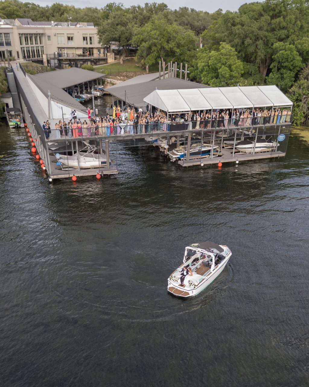 Aerial view of the lakeside dock wedding cocktail hour and boat arrival at Westwood Country Club with drone