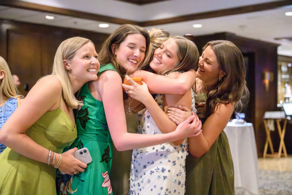 Maddy embraces friends during her Austin rehearsal dinner celebration