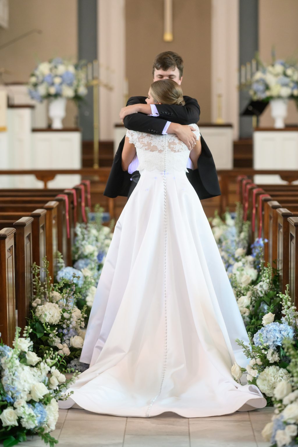 Maddy embraces her groom during their first look inside Tarrytown United Methodist Church