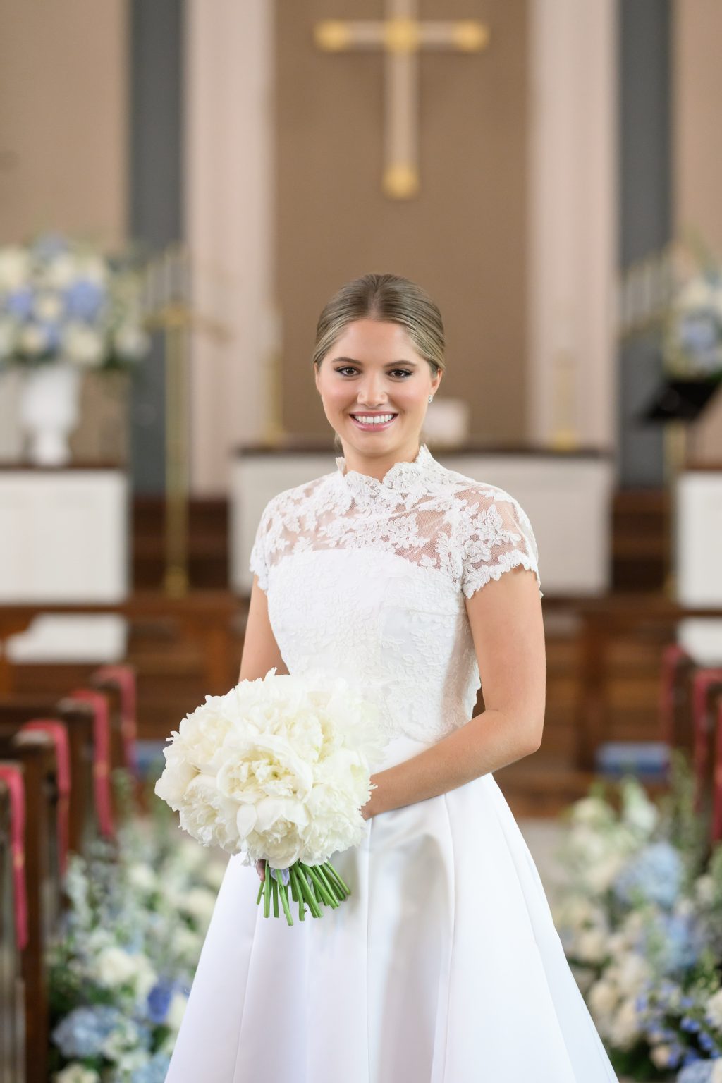 Bride holds a white bouquet inside Tarrytown United Methodist Church in Austin