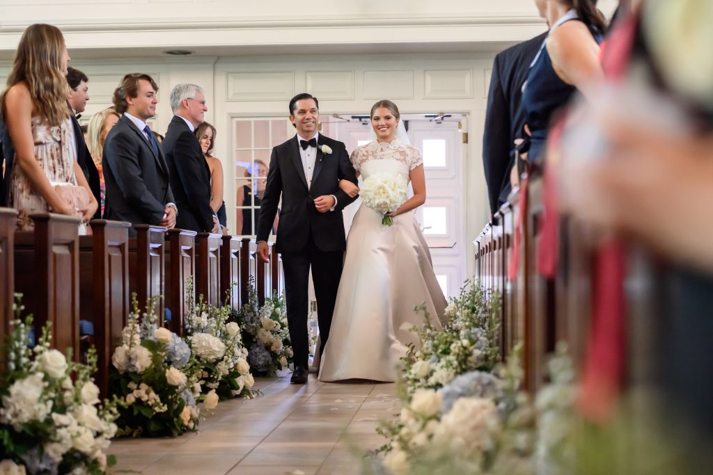 Maddy walks down the aisle with her father at Tarrytown United Methodist Church