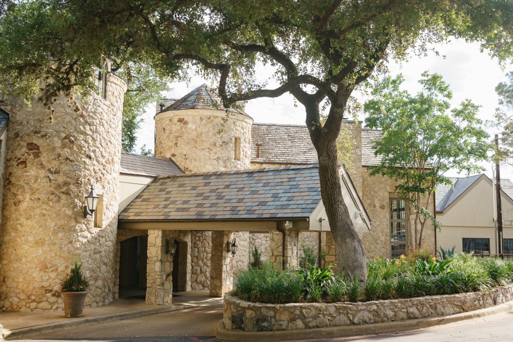 Stone clubhouse and oak trees at Westwood Country Club in Austin