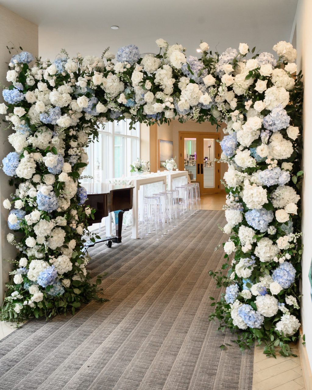 Blue and white floral arch designed for the entrance to the wedding reception