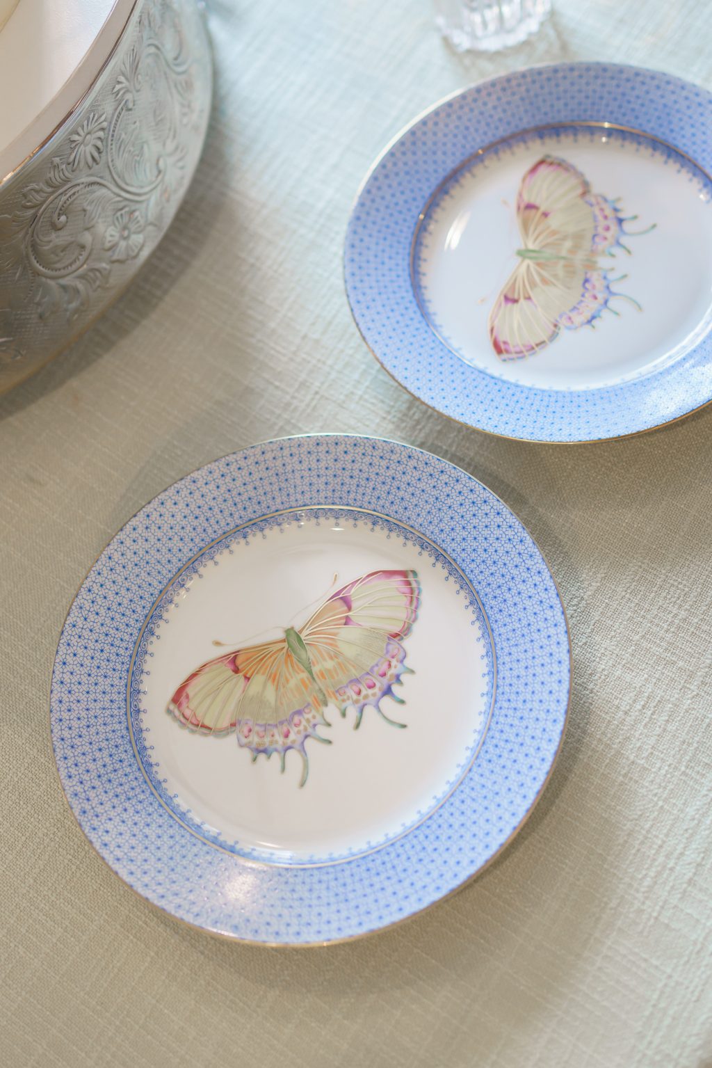 Hand-painted butterfly plates used as a meaningful detail in the wedding design