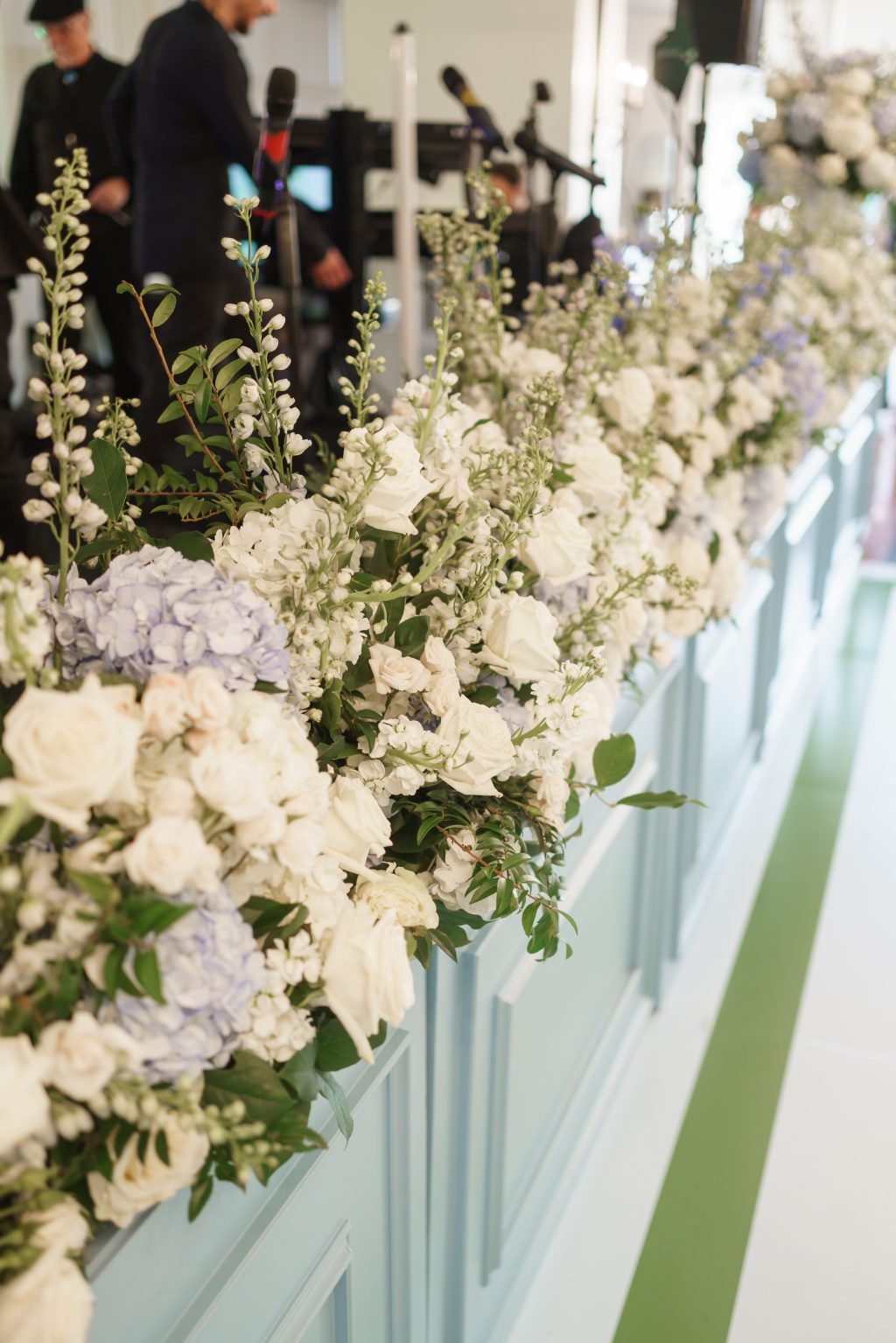 Layered white and pale blue flowers decorate the Westwood Country Club reception bar