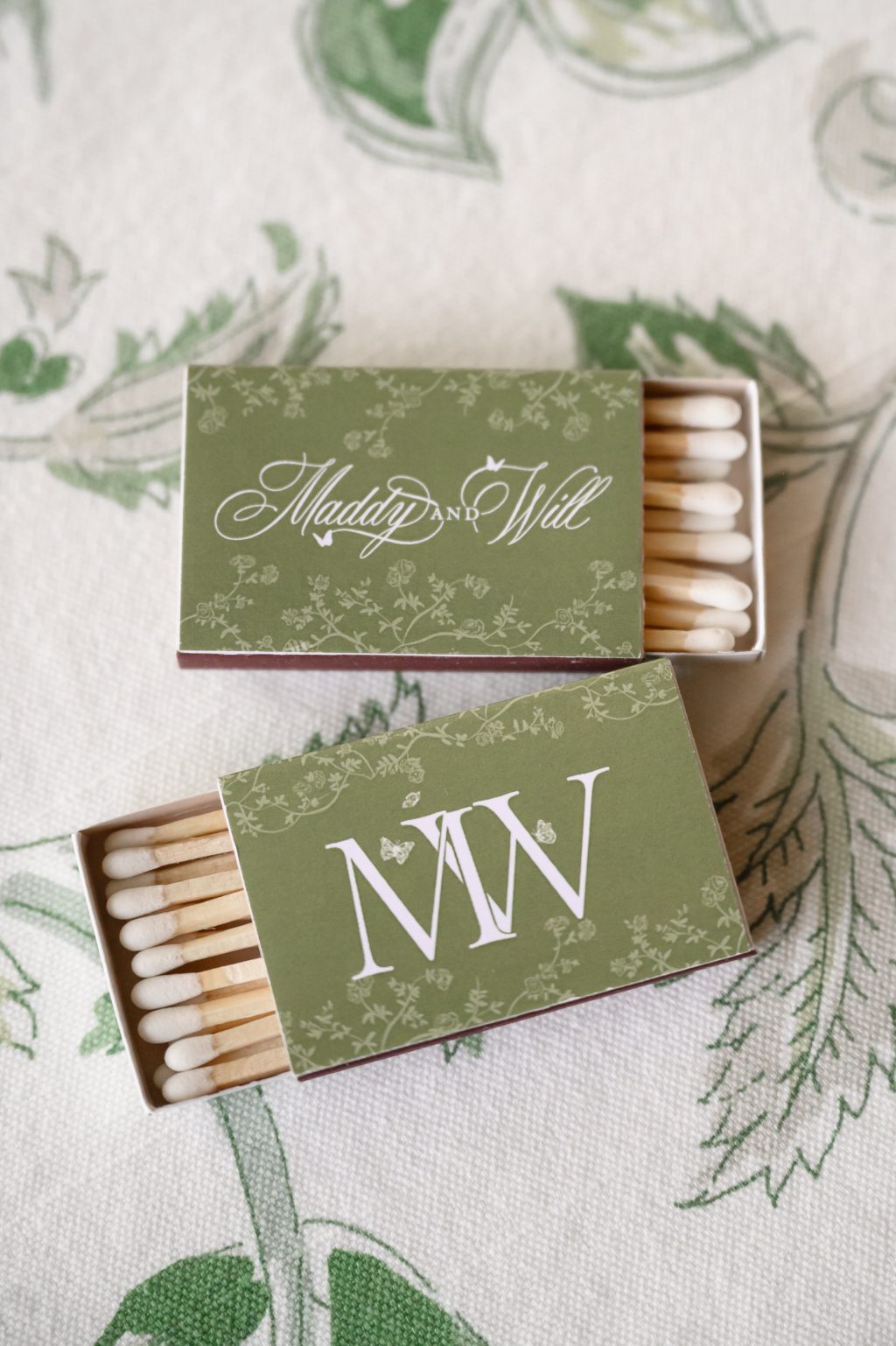 Green monogrammed matchbooks created for Maddy and Will’s Westwood Country Club wedding