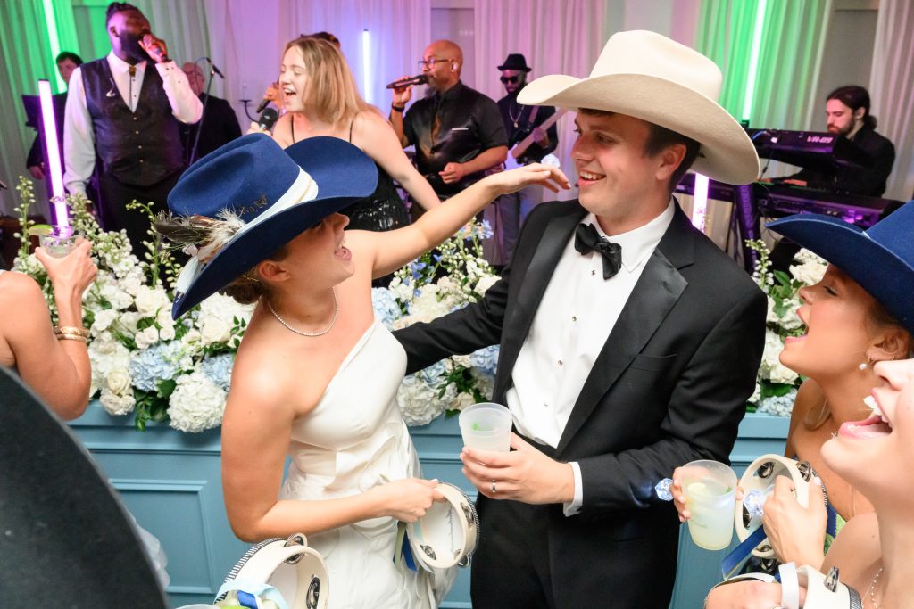 Maddy and Will celebrate with guests during their lively country club wedding reception
