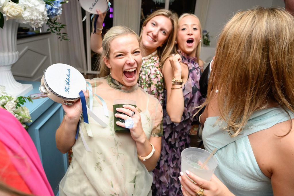 Friends laugh together during Maddy and Will’s Westwood Country Club reception