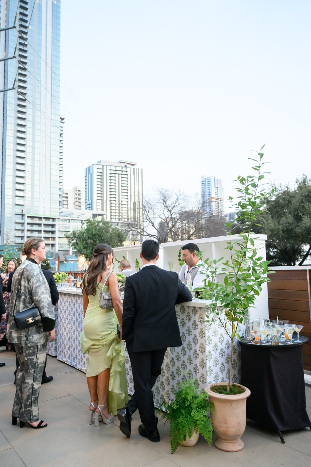 Guests getting at drink at the bar on the terrace at the Four Seasons