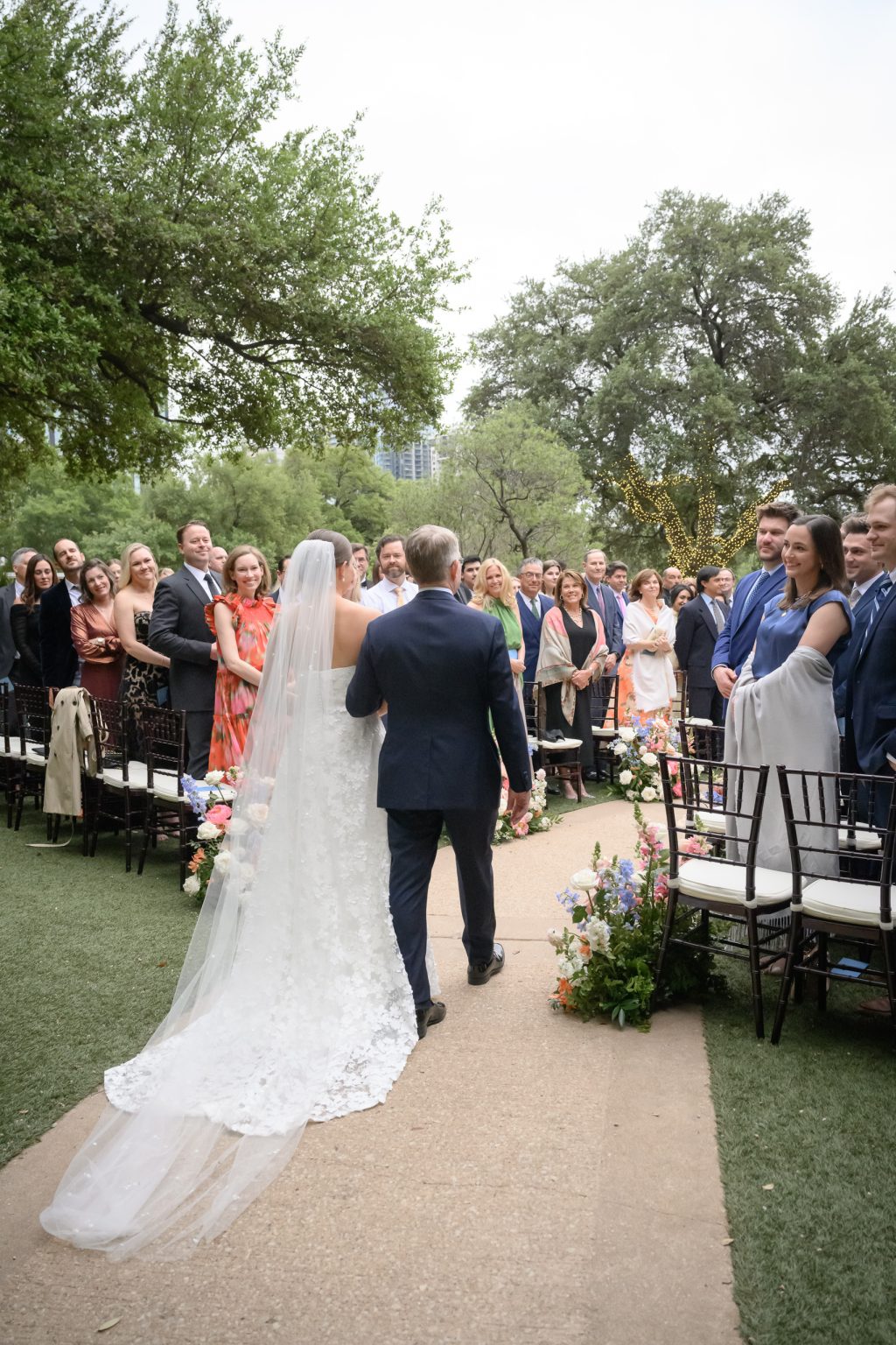 Father and daughter walking down the aisle at the lake view ceremony on the lawn at Four Seasons