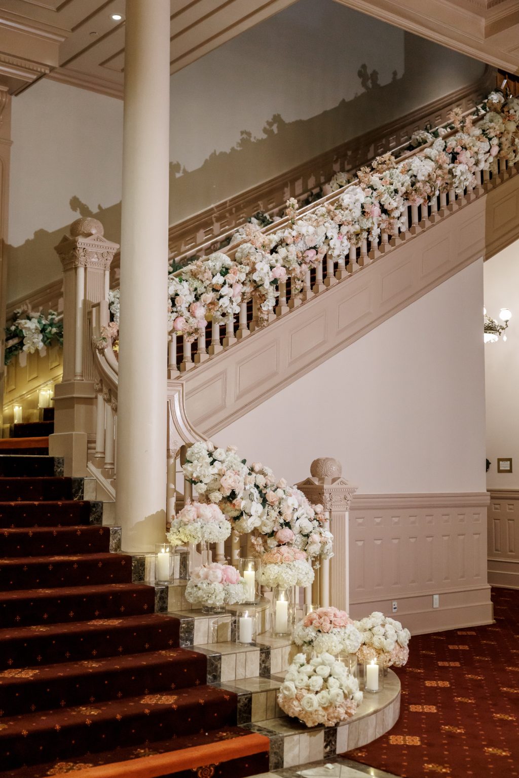 Grand staircase decorated with florals on the railing