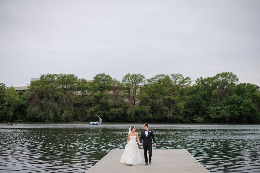 Bride and groom standing together at the end of the dock on Lady Bird Lake
