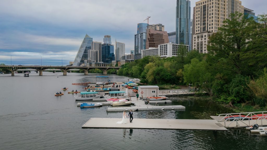 Austin skyline seen beyond the dock during wedding portraits at Four Seasons Austin