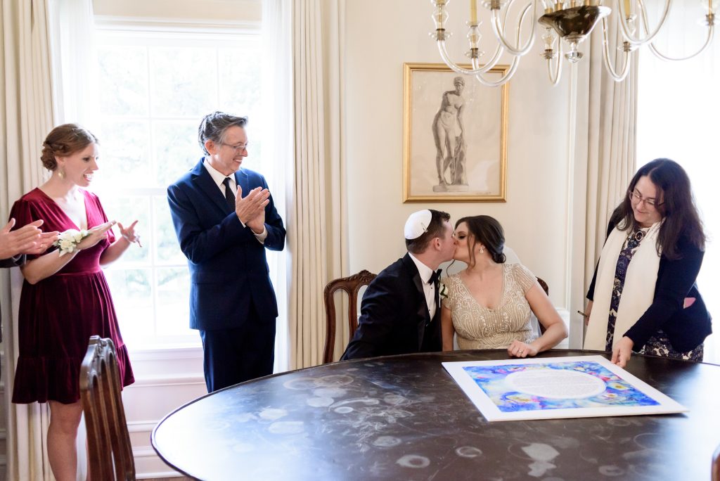 Bride and groom signing their Khatuba in the Mr. and Mrs. Perry suite at Commodore Perry
