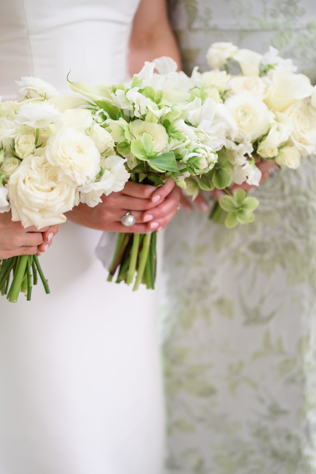 Bride holding a white and green wedding bouquet with roses and hydrangea