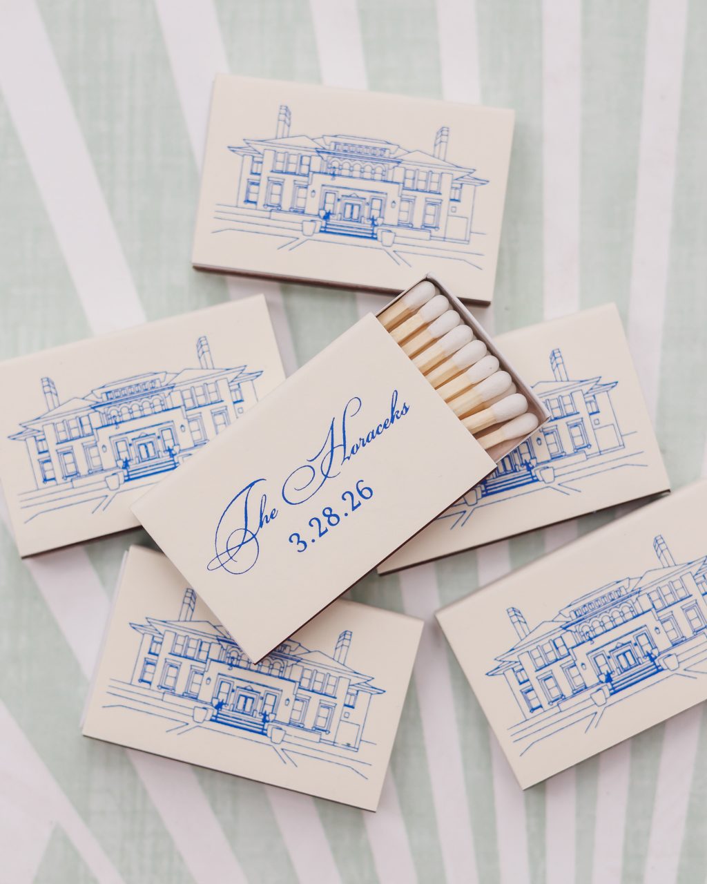 Custom blue and white wedding matchbooks featuring an illustration of La Colombe d’Or