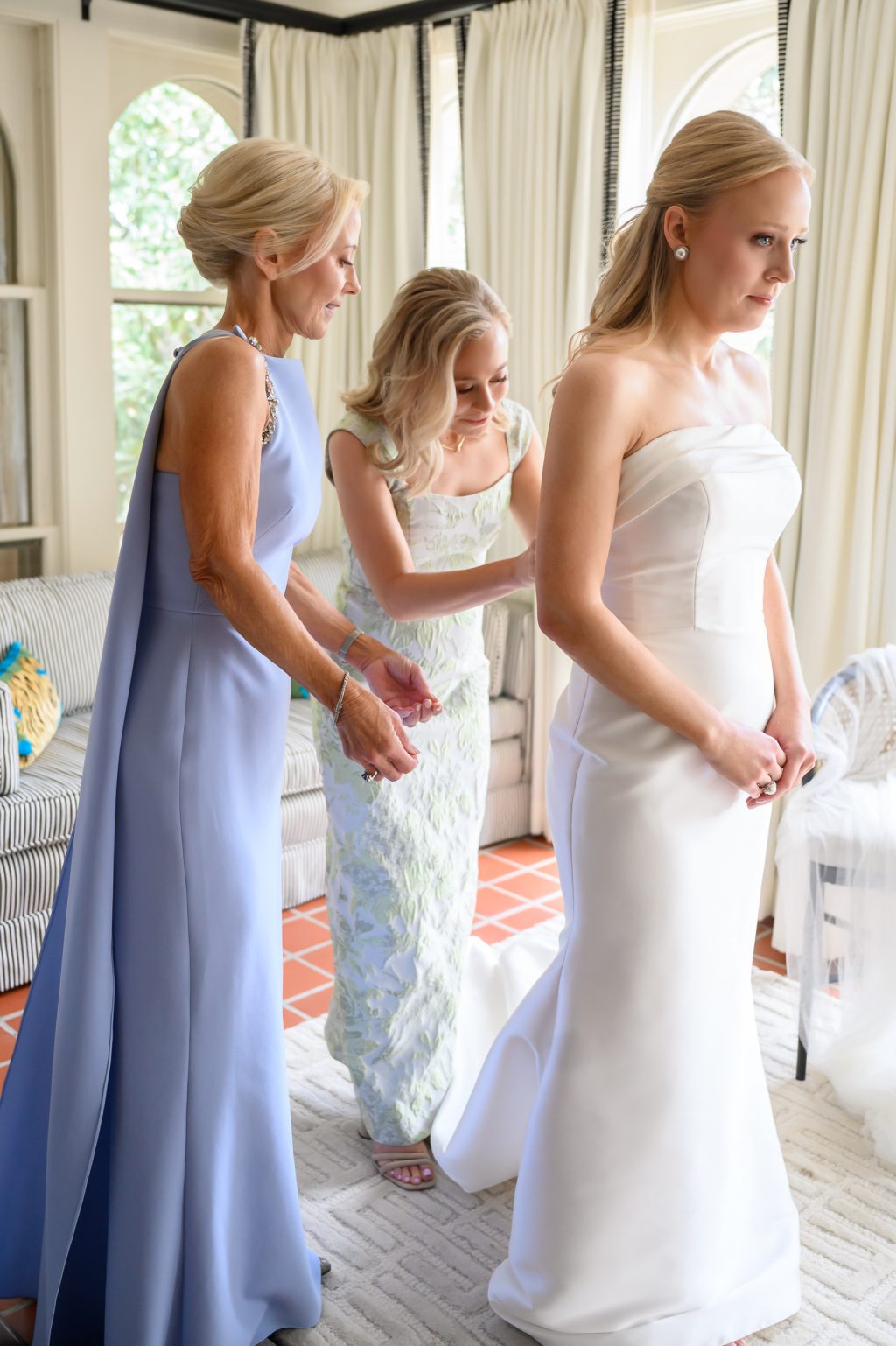 Bridesmaids helping the bride with final details before her La Colombe d’Or wedding