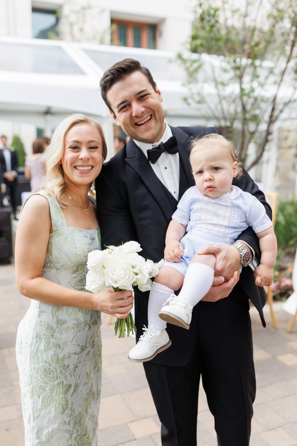 Wedding guests smiling with the groom during portraits at La Colombe d’Or