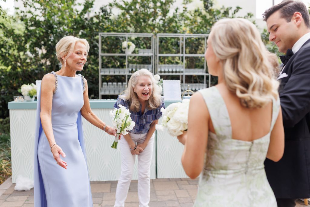 Family laughing together during wedding portraits in the La Colombe d’Or courtyard