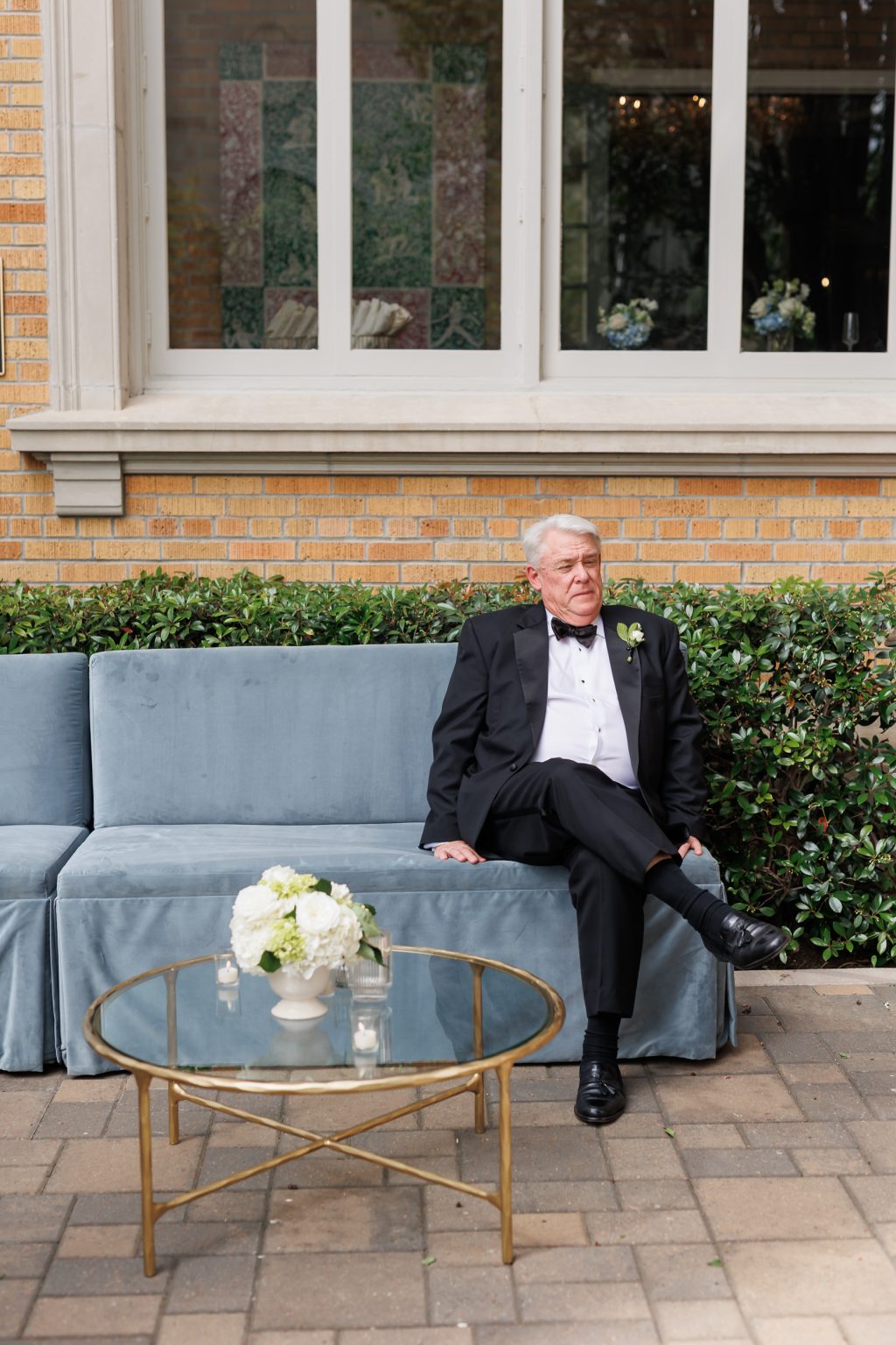 Wedding guest seated outside La Colombe d’Or before the ceremony