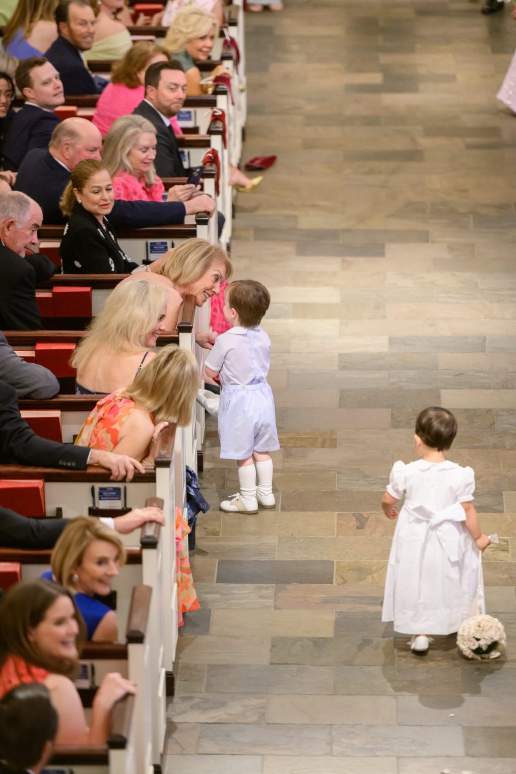 Young flower girls walking down the aisle at St. Luke’s Methodist Church in Housto