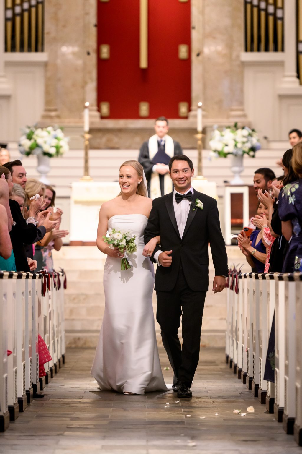 Bride and groom walking back down the aisle after their Houston church ceremony