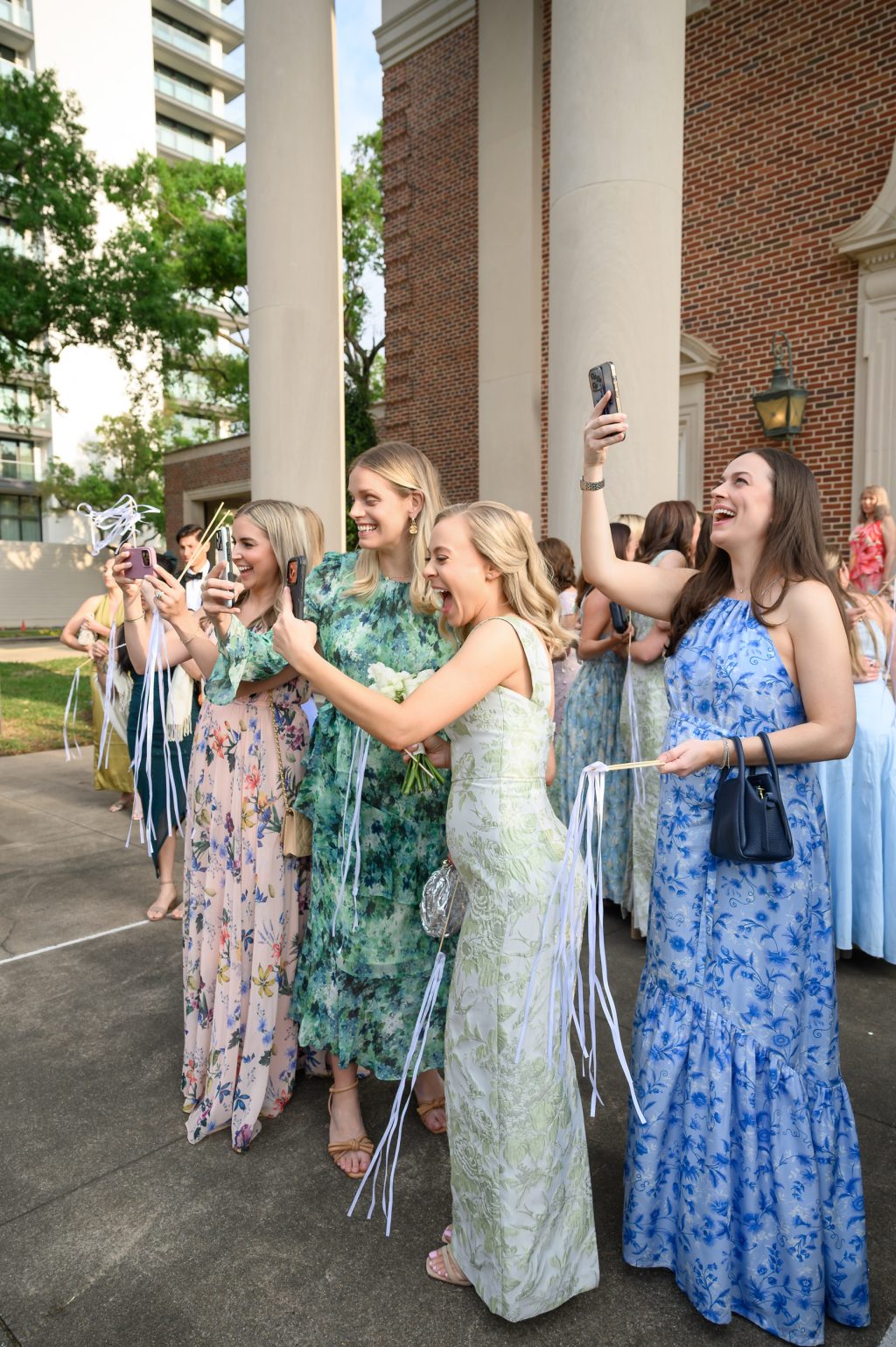 Wedding guests cheering outside St. Luke’s Methodist Church after the ceremony