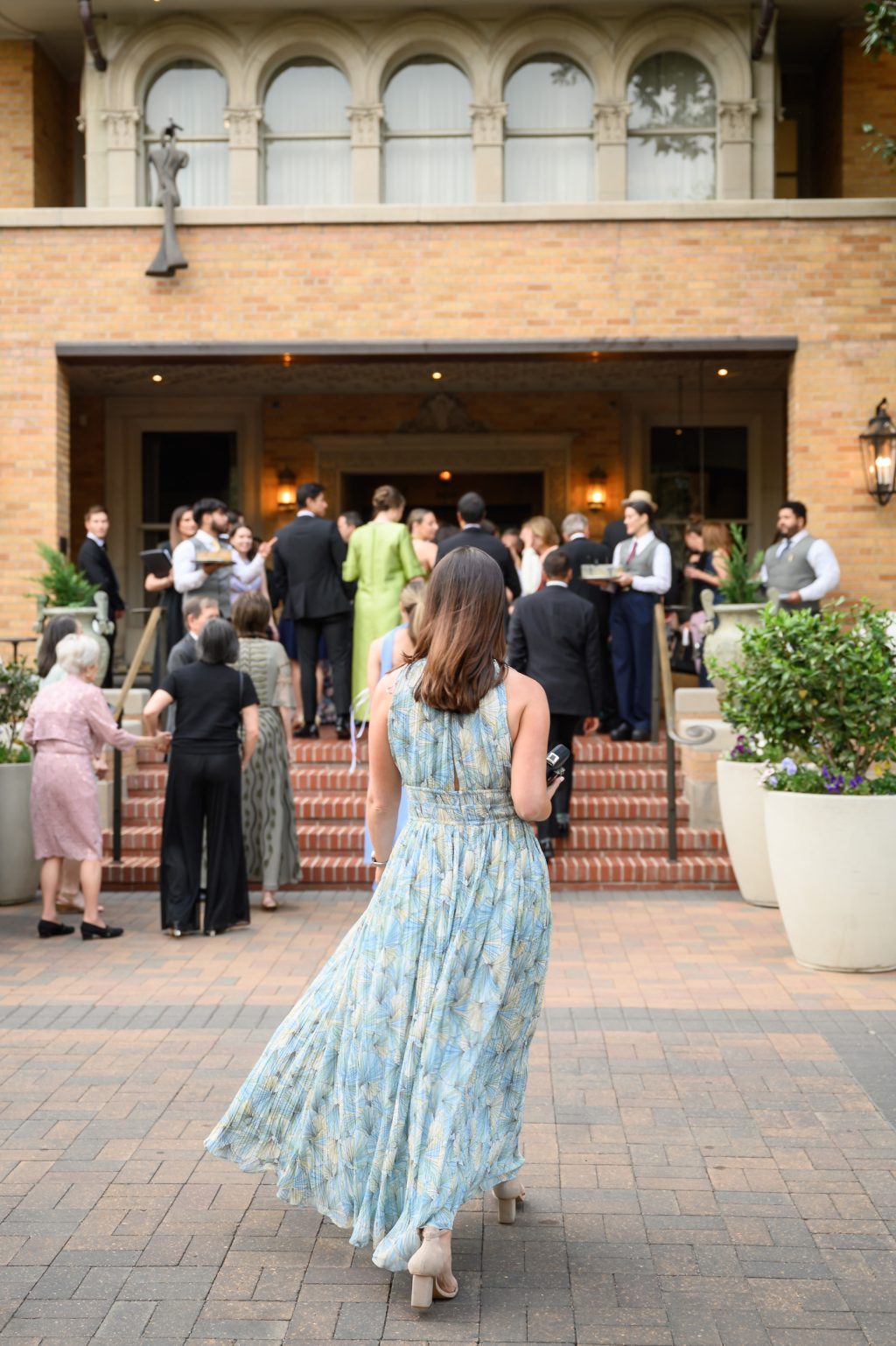 Wedding guests gathering outside the historic La Colombe d’Or mansion in Houston