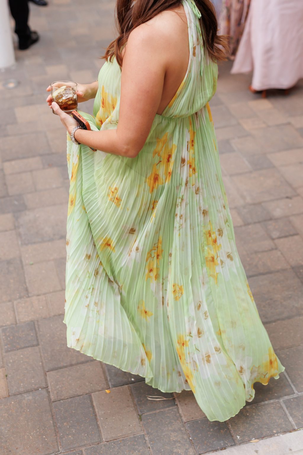 Wedding guest in a green floral dress during the La Colombe d’Or reception
