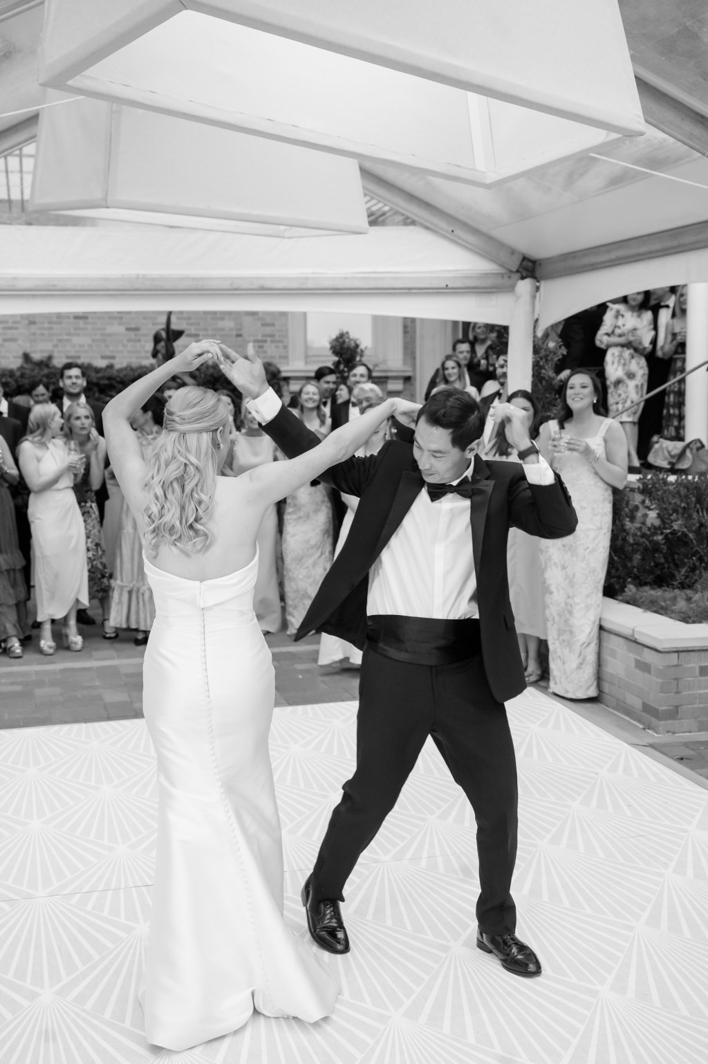 Black and white photograph of the bride and groom dancing at their Houston wedding