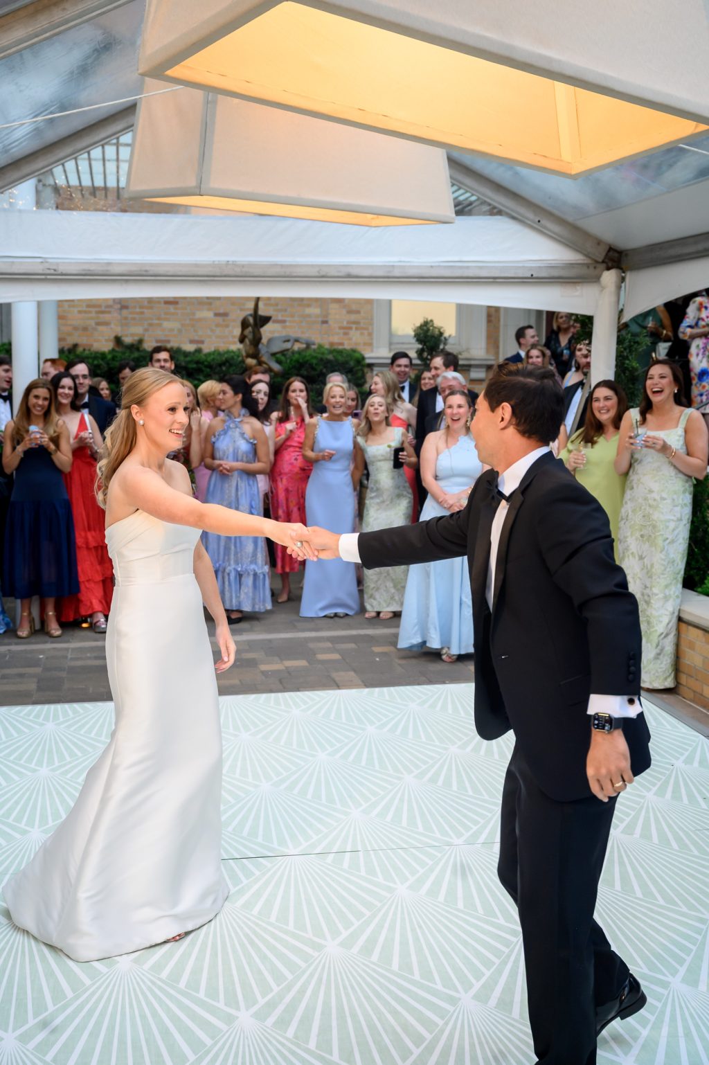 Bride and groom dancing together surrounded by wedding guests at La Colombe d’Or