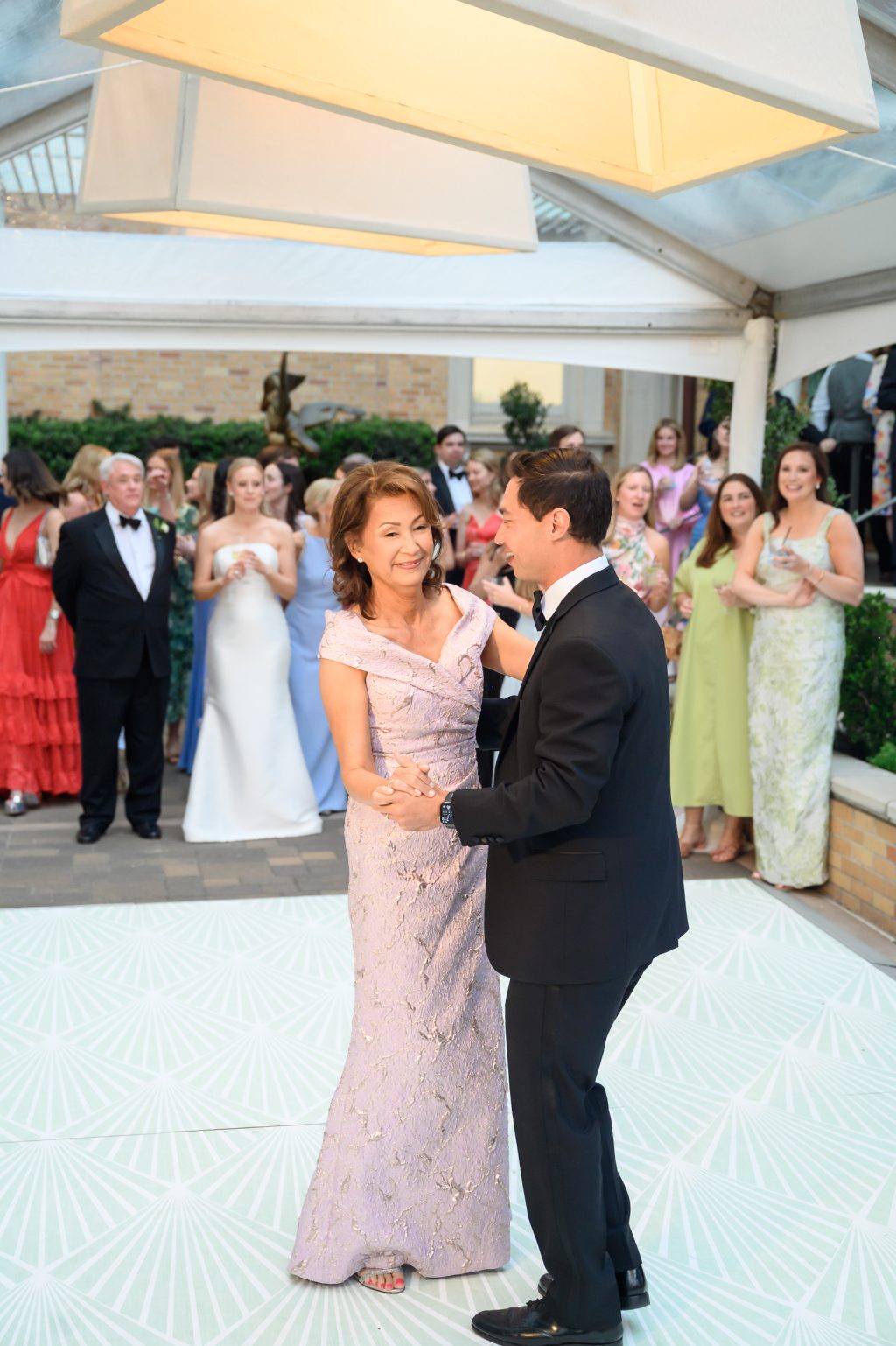 Groom dancing with a family member during the La Colombe d’Or wedding reception