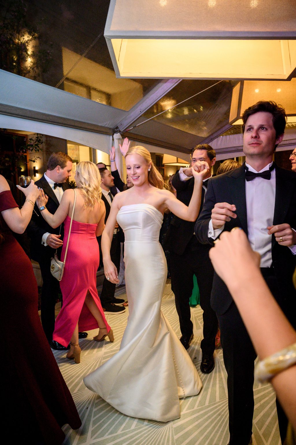 Bride dancing with guests during the reception at La Colombe d’Or in Houston