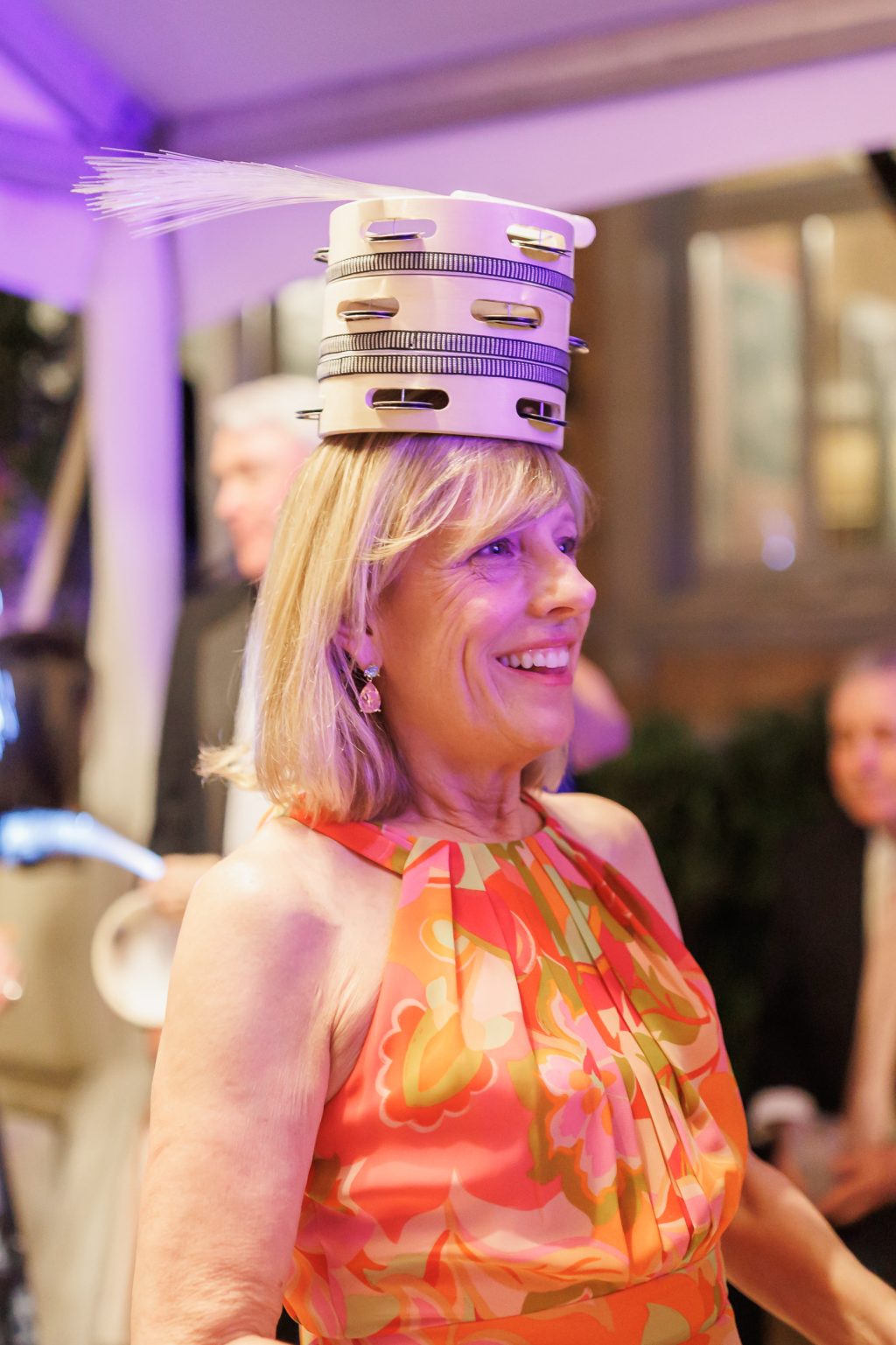 Wedding guest wearing a playful personalized party accessory during the reception