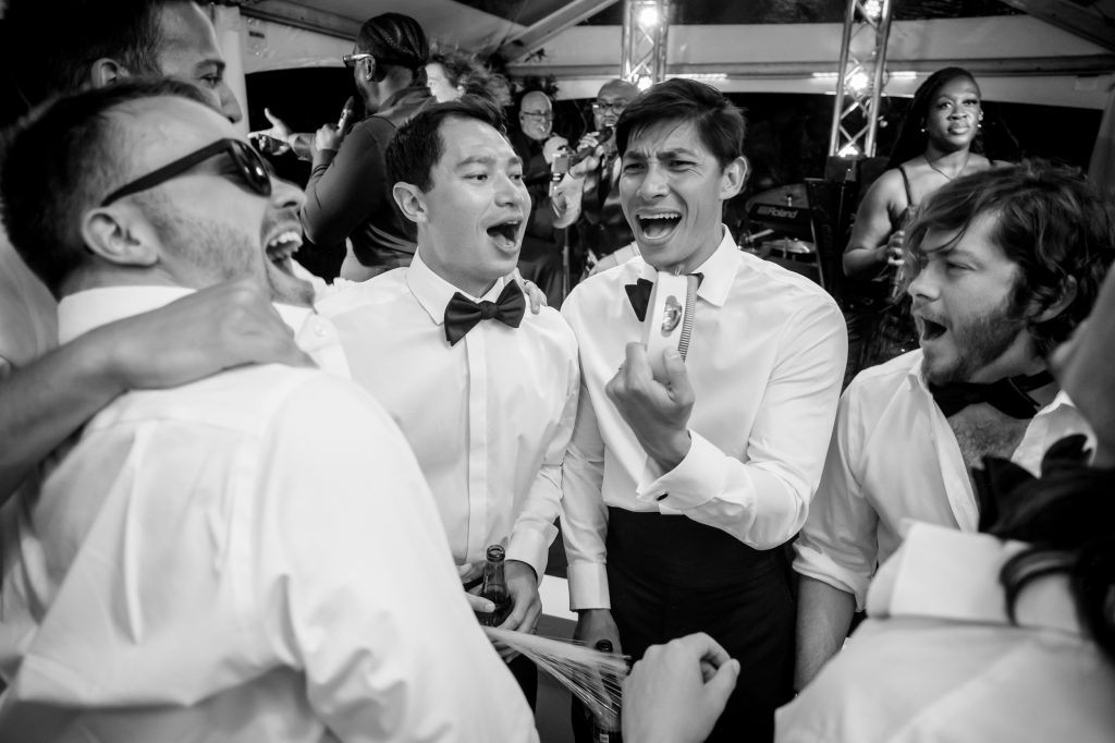 Black and white candid of guests singing and dancing at the La Colombe d’Or reception