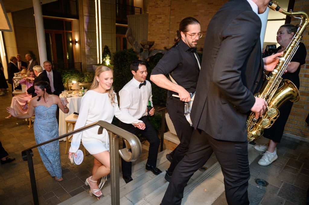 Live band performing the second line as wedding guests head to the after party inside the bar