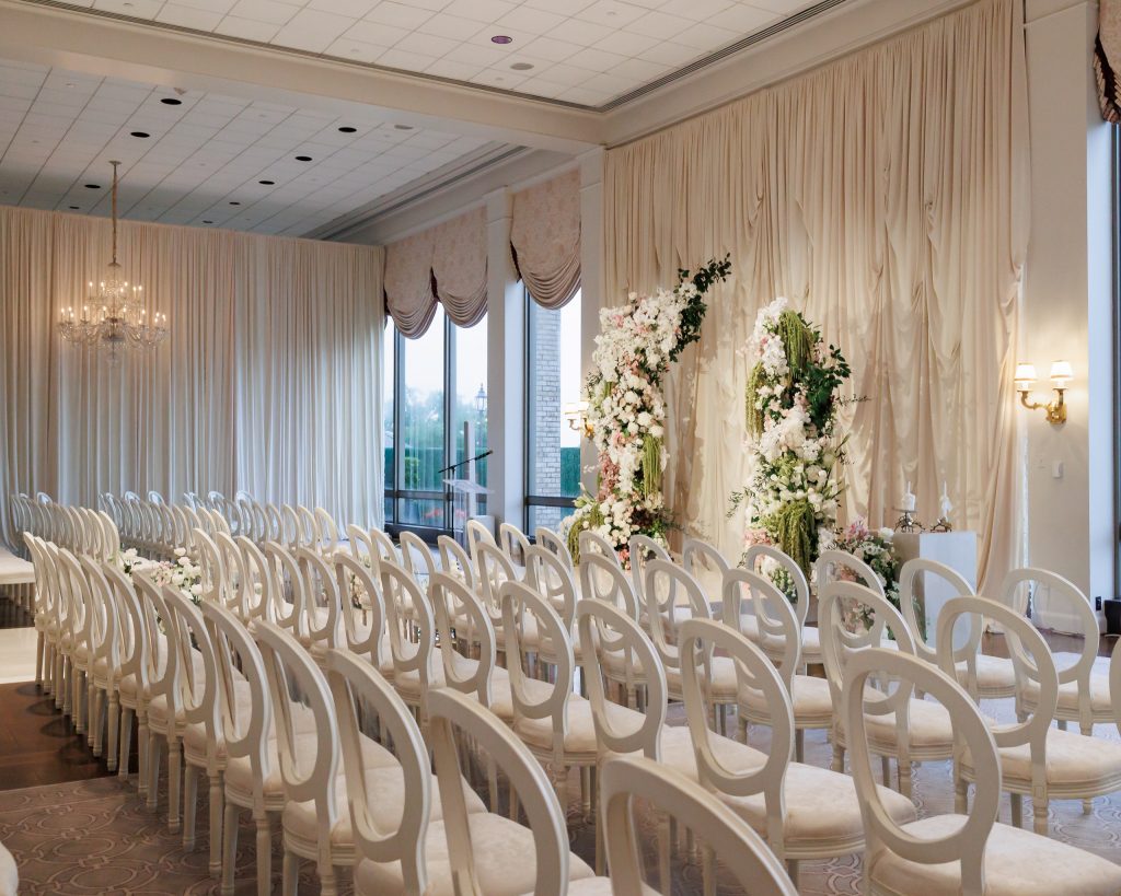Wide view of the Main Dining Room arranged for a wedding ceremony at River Oaks Country Club