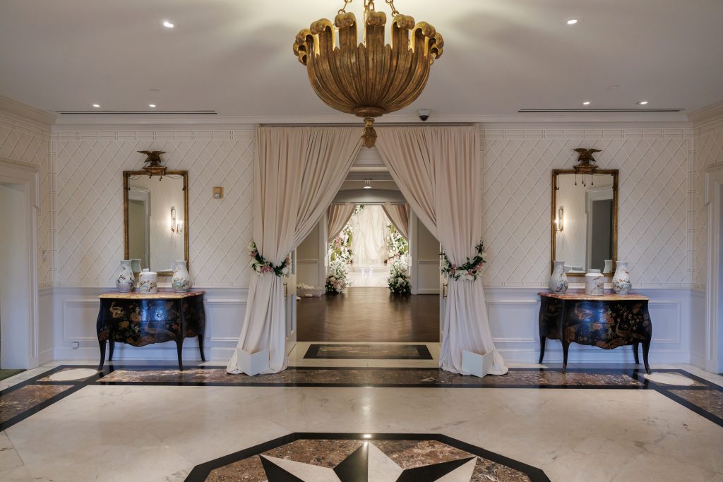 Draped entrance leading into an indoor wedding ceremony at River Oaks Country Club
