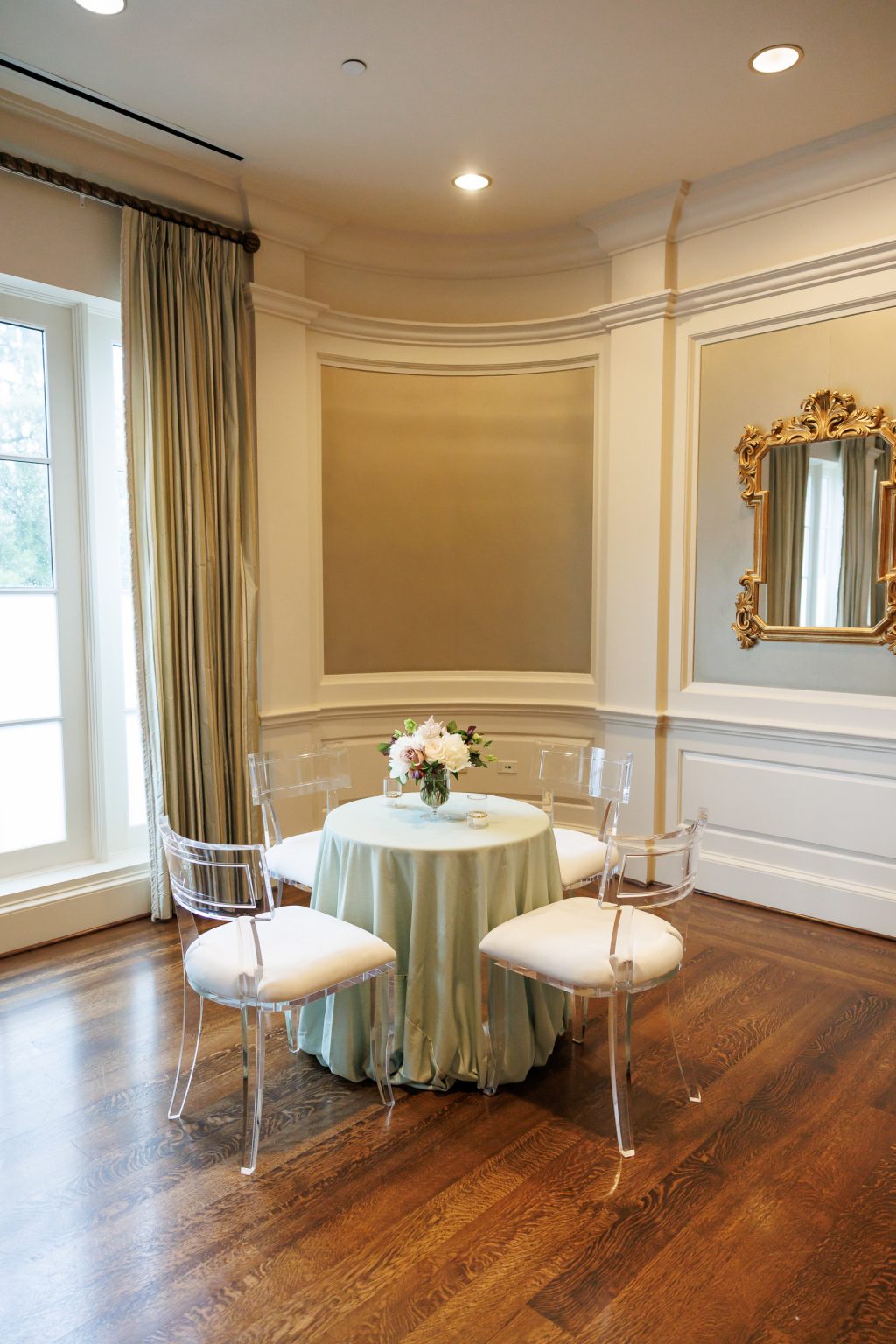 Small cocktail table beside a window in the Salon at River Oaks Country Club