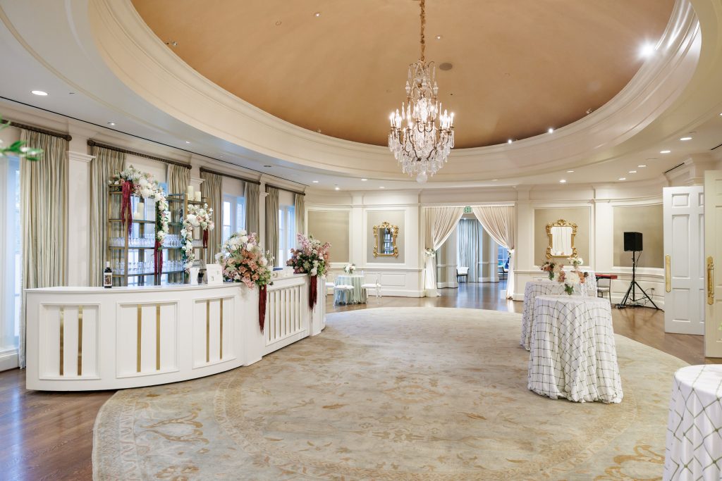 Wide view of the Salon at River Oaks Country Club prepared for wedding cocktail hour